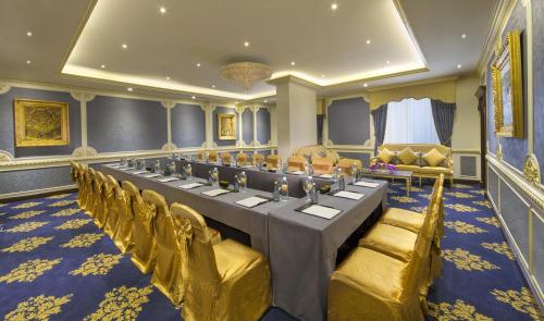 a conference room with a long table and chairs at Royal Rose Abu Dhabi, a Curio Collection by Hilton Affiliated Hotel in Abu Dhabi