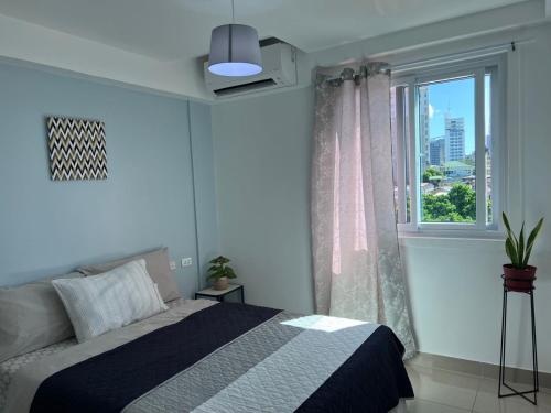 a bedroom with a bed and a window at Cebu Mini Hotel in Cebu City