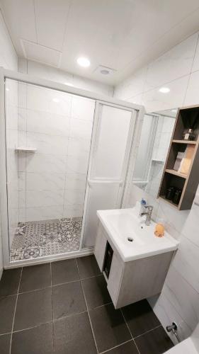 a bathroom with a shower and a white sink at Stay if you wish Homestay in Jiufen