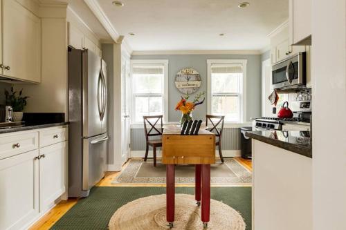 a kitchen with a table with a vase of flowers on it at The Seaport House - Near Newport in Bristol