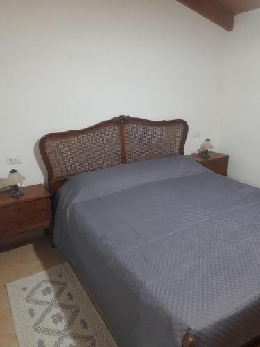 a bed in a room with two nightstands and a bed with a blue at Appartamento centro in SantʼAntìoco