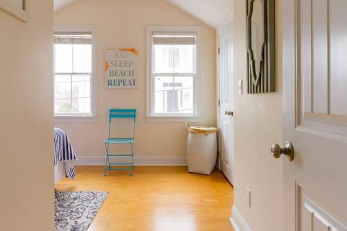 a hallway with a blue chair in a room at The Seaport House - Near Newport in Bristol