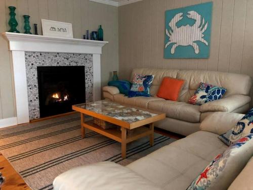 a living room with two couches and a fireplace at The Seaport House - Near Newport in Bristol