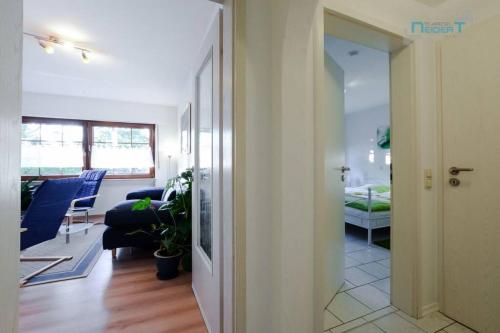 a hallway leading to a living room with a couch at Ferienwohnung Tor zum Spessart in Wächtersbach