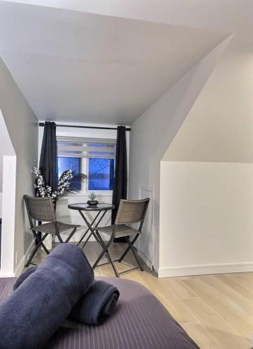 a living room with a couch and a table with chairs at PANORAMA DE LA DETENTE-BORDURE DE FLEUVE (309418) in Saint-Laurent-de-l'ile d'Orleans