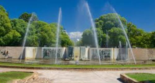 una fuente en un parque con árboles en el fondo en Departamento en Mendoza Capital en Mendoza