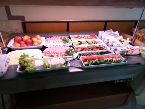 a buffet with many different types of food on a table at Hotel Eiserner Anton in Bielefeld