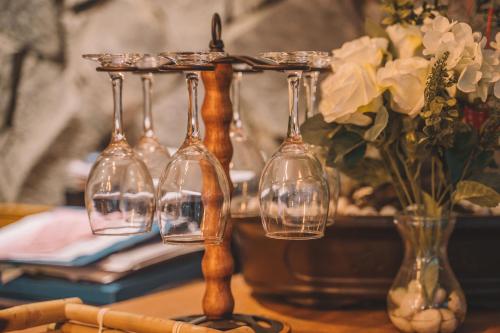 a group of wine glasses on a table with vases at Zhangjiajie National Park Nvue Resorts in Zhangjiajie