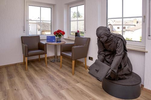 a statue of a woman sitting on a table in a waiting room at Keller Höhe in Andernach