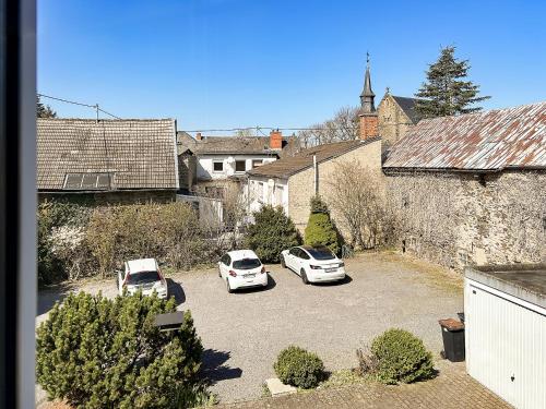 two cars parked in a parking lot in a village at Keller Höhe in Andernach