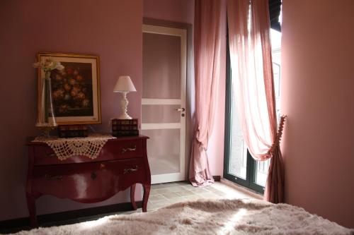 a bedroom with a dresser and a window at C'ERA UNA VOLTA - casa vacanza Etna-Sicilia-mare in Linguaglossa