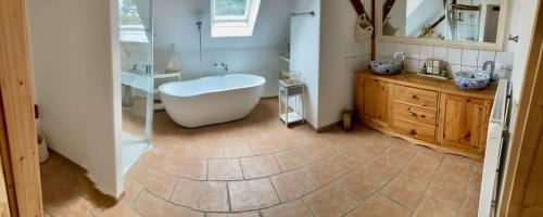 a bathroom with a tub and a sink at derHofRat in Litzelsdorf