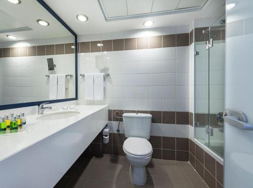 a bathroom with a toilet and a sink and a shower at Sport Club by Isrotel Collection in Eilat
