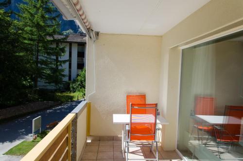 a patio with a table and chairs on a balcony at Haus Cristal - 1441m in Leukerbad