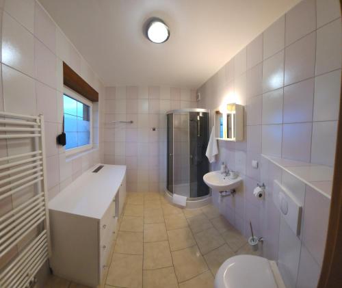 a white bathroom with a sink and a toilet at Willa Sielanka in Karpacz
