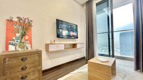 a living room with a tv and a large window at LAD Apartment & Homestay Hải Phòng - Hoàng Huy Grand Tower in Hai Phong