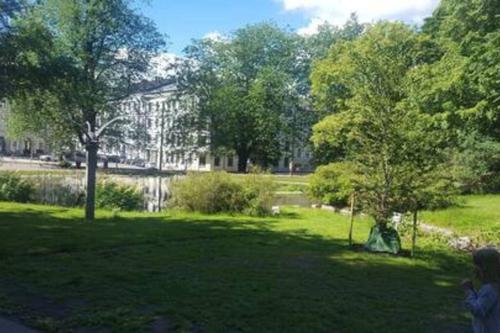 a park with trees and a building in the background at 4 bedroom flat in the heart of Oslo in Oslo