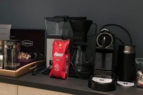 a counter with a coffee maker and other items on it at 4 bedroom flat in the heart of Oslo in Oslo