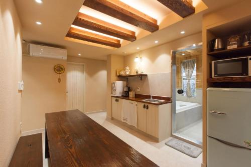 a kitchen with a wooden table in a room at Jeonju Hanok Little Prince in Jeonju
