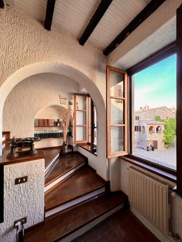 a room with a large window in a building at La Casa del Castello in Montemerano