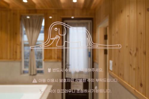a kitchen with a trash can and a mirror at Jeonju Hanok Little Prince in Jeonju