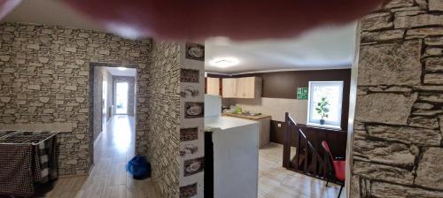 a kitchen with a stone wall and a kitchen with a counter at NOCLEGI u ALI in Wałbrzych