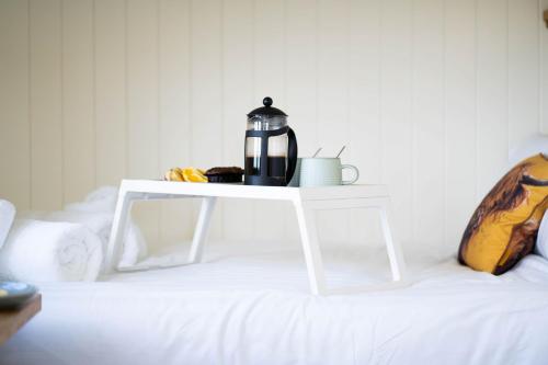 a coffee maker on a white table on a white couch at The Shepherd's Hut in Penzance