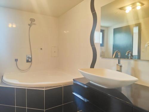 a bathroom with a sink and a bath tub at la lapia in Monthey