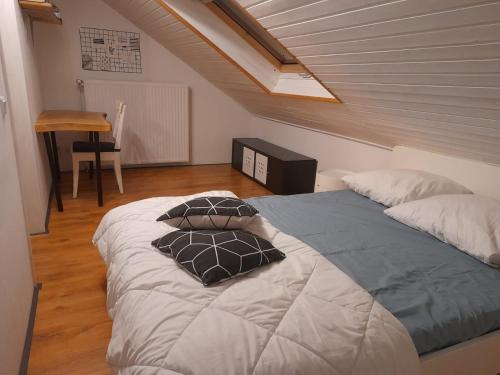 a bedroom with two beds with pillows on it at Haus Konthé, appartement in Winterberg