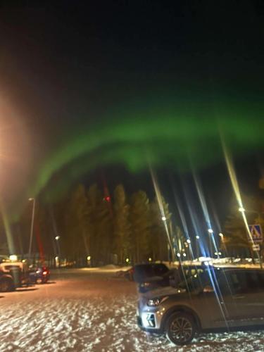 a car parked in a parking lot at night at Charming room with big bed in Luleå