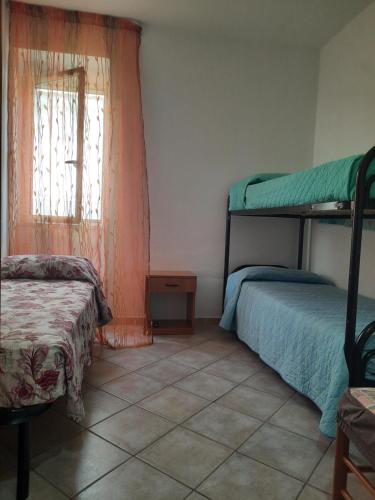 a bedroom with two bunk beds and a window at Casa da Tonia Peschici in Peschici