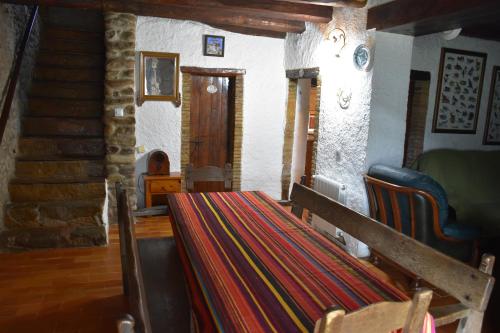 Habitación con mesa, sillas y escalera. en Can More El Pasteral, en La Cellera de Ter