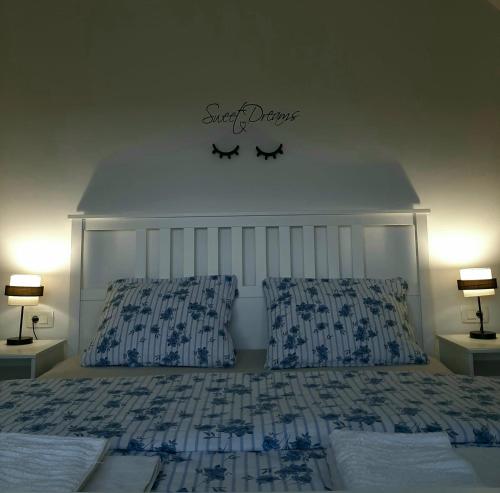 a bedroom with a bed with a headboard and two lamps at Elegant Inn Gospić in Gospić
