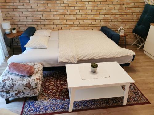 a bedroom with a bed and a brick wall at Višnja-Ravnice in Zagreb
