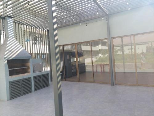 a large building with glass windows and a grill at Hermoso departamento nuevo amoblado in Arica