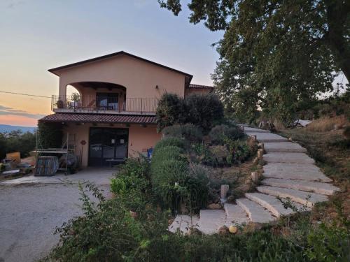 a house with a staircase leading up to it at La Residenza di Campagna in Manciano