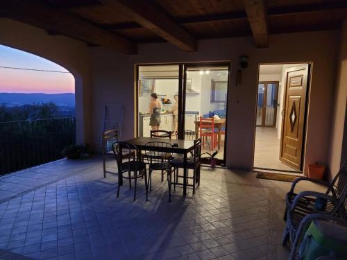 a patio with a table and chairs on a balcony at La Residenza di Campagna in Manciano