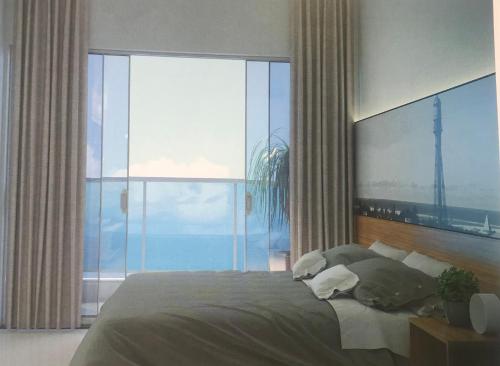 a bedroom with a large bed with a large window at Salinas Premium Resort in Salinópolis