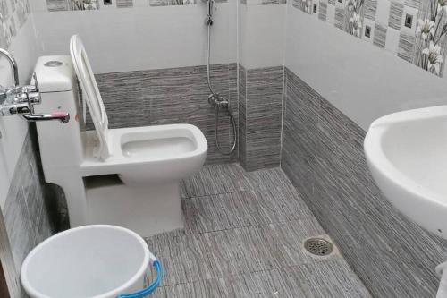 a bathroom with a toilet and a sink at 2 Bhk Fully Furnished Hafeezpet #101 in Hyderabad