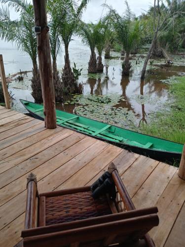 a wooden deck with a view of a body of water at Glamping Lakeview Ouidah in Gakpé
