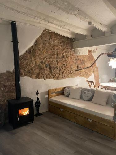 a bedroom with a bed and a fireplace at El Secret de la LLegenda El Drac in Vilavert