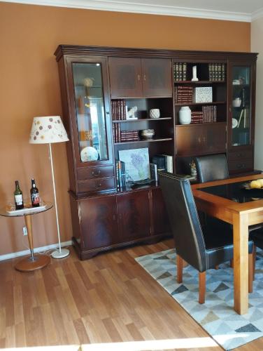 an office with a wooden desk and a table at Alameda Residence in Tomar