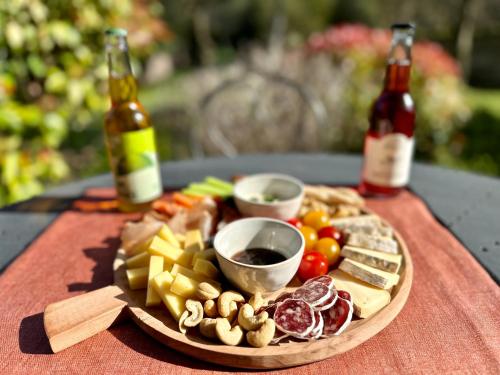 a plate of food on a table with bottles of beer at LA DEMEURE in Précy-sur-Oise