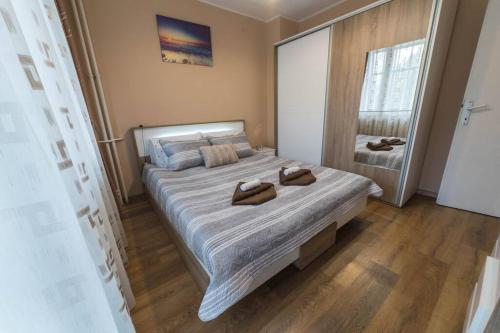 a bedroom with a large bed with two towels on it at Marvelous Riverside Flat in Ruse