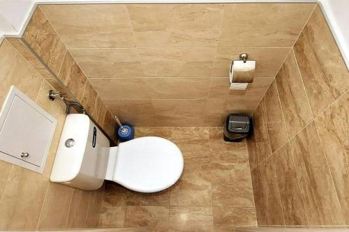 a bathroom with a toilet and a sink at Marvelous Riverside Flat in Ruse