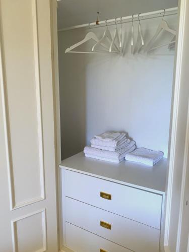 a closet with white cabinets and white towels at Dream Apartment in Mijas Golf Limonar in Mijas Costa