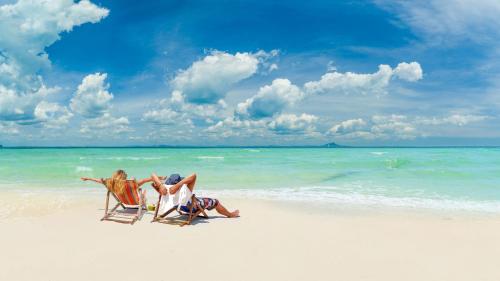 two people sitting in lawn chairs on the beach at Holiday Inn Express Hyderabad Banjara Hills by IHG in Hyderabad