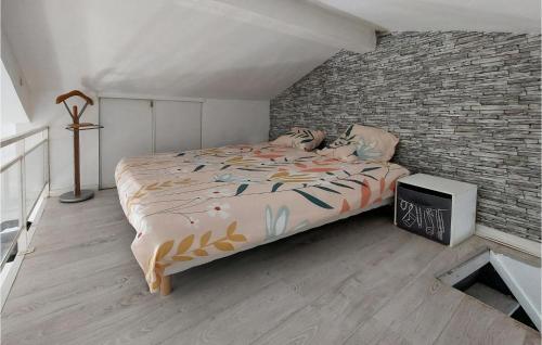 a bedroom with a bed and a brick wall at 4 Bedroom Awesome Home In Villars in Villars