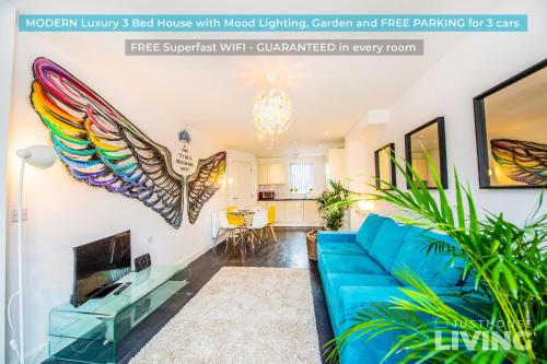 a living room with a blue couch and wings on the wall at Liverpool House - Stunning Townhouse with FREE Parking for 4 cars - Close To Centre in Liverpool