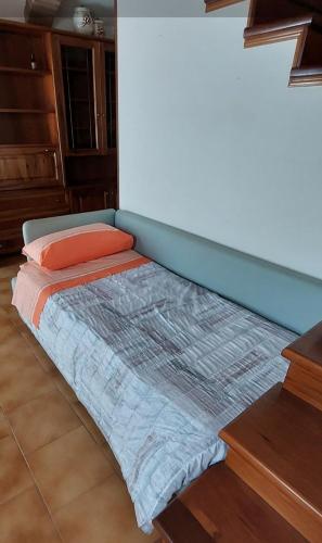 a bed in the corner of a room at Casa Adige in Verona